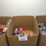 Cardboard boxes filled with boxed and canned food.
