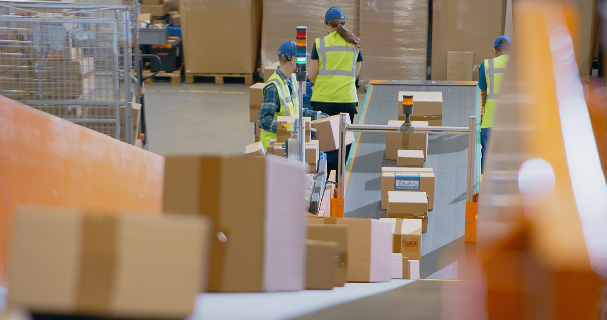A group of people in a warehouse.